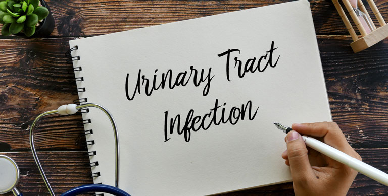 Urinary Tract Infection on notebook on wooden background