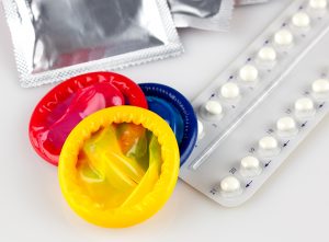 Photo of condoms and oral birth control pills